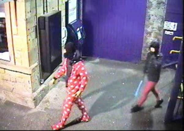 Two men were captured on CCTV last Monday. One of the monitors is pictured in the background.