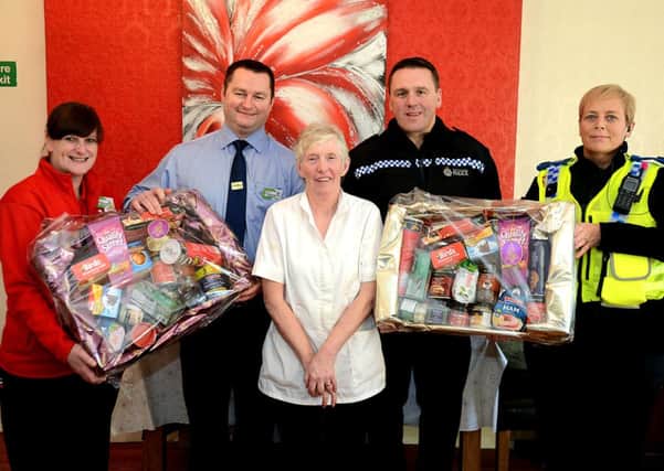 Police & Asda present Christine Pygott, The Beeches care home worker stab victim with a christmas hamper.
Pictured L) to R) Louise Brown - Asda community colleague, Gary Danvers - Asda store manager, Christine Pygott, Inspector David Bugg, PCSO Dawn Dickinson.
p308a449