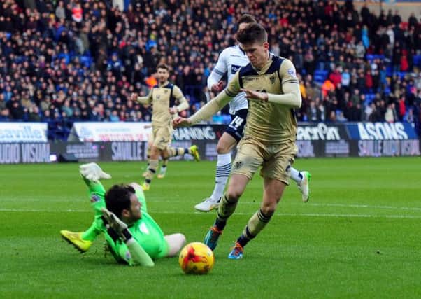 Leeds United's Sam Byram wins his side a penalty as he tries to round Bolton goalkeeper Andrew Lonergan at the Macron Stadium. Picture: Tony Johnson