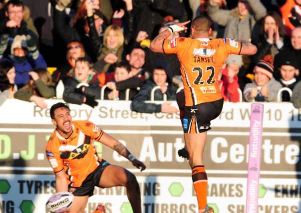 Supporters enjoying the opening game of the new Super League season at the Mend-A-Hose Jungle as Denny Solomona celebrates scoring a try with team-mate Jordan Tansey.