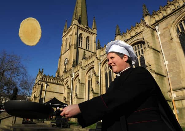 Canon Toni Hofbauer pancake tossing at Wakefield Cathedral.