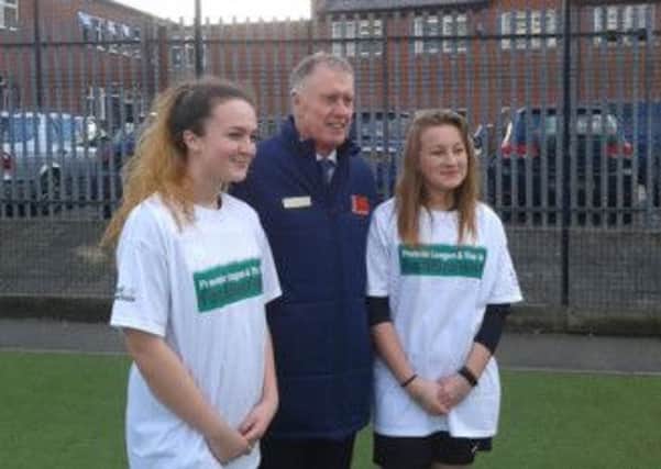 Sir Geoff Hurst with Jasmine Hazell and Tyler Carter from Castleford White Rose Ladies FC.