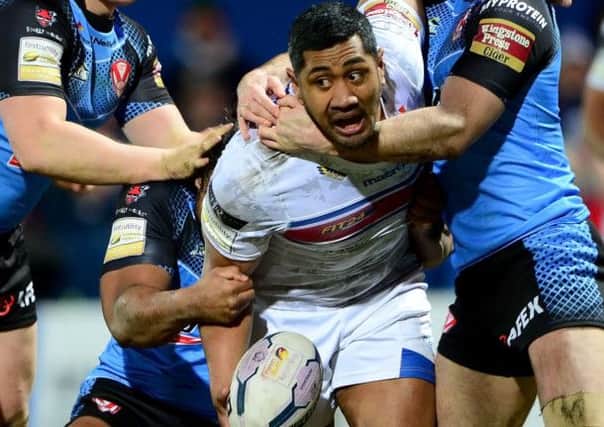 Wildcats forward Ali Lauitiiti takes on the St Helens defence in Friday's game.