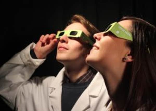 Staff from Wakefield College's marketing department modelling solar eclipse glasses.