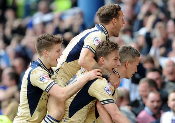 Steve Morison is mobbed by his team-mates after scoring the winning goal for Leeds United at Sheffield Wenesday. Picture by Simon Hulme
