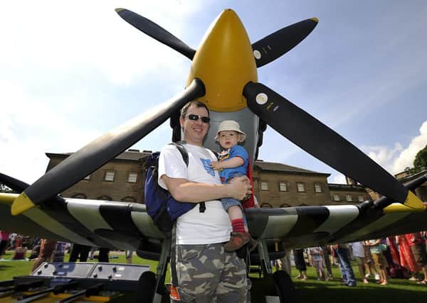 Ivan Routledge with his son James age one year, in front of a Spitfire on display at Wakefield Council annual Armed Forces Day at Nostell Priory.