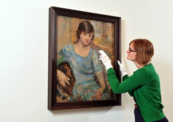 Curator Eleanor Clayton with the portrait of the young Barbara Hepworth. Picture by Tony Johnson