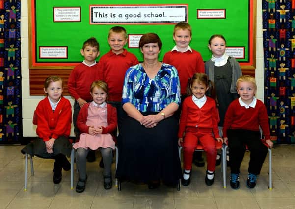 Newspaper: Pontefract & Castleford Express.
Story: Wheldon Infants school, Castleford, has gone from 'requiring improvement' to "Good" in a recent Ofsted report.
Picture shows head teacher Tracey Lake with pupils chosen to represent the school.
Photo Date: 18/05/15
Photo Ref: AB035a0515
