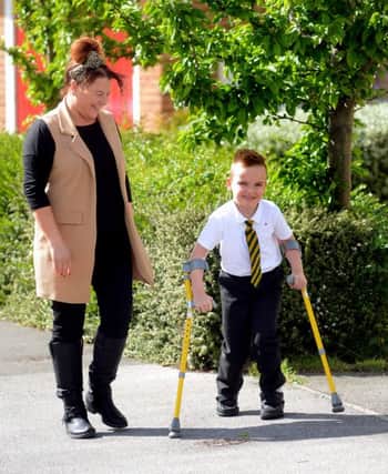 Newspaper: Pontefract & Castleford Express.
Story: Cameron Harper from Whitwood, Castleford. Cameron who has Cerebral Palsy, had an operation earlier during 2015 which is designed to help him walk for the first time.
Pictured with his delighted mum, Nicola.
Photo Date: 18/05/15
Photo Ref: AB036b0515