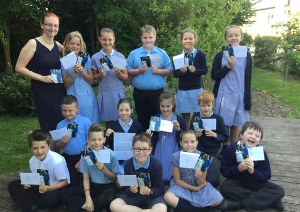 Stanley grove primary school received letters from Kensington Palace after sending a book to Prince George about how to look after Princess Charlotte. Joanne Kershaw with class five pupils.