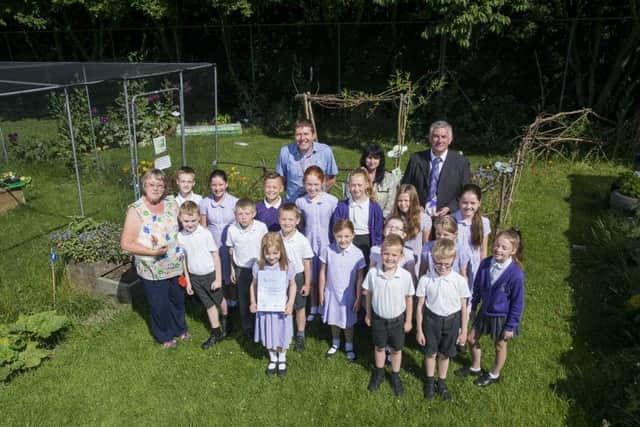 Picture by Allan McKenzie/YWNG - 03/07/15 - Press - Lofthouse School Awards - Outwood Primary Academy, Lofthouse, Wakefield, England - Jonathan Stone (Chairman of Governors), Jackie Savage (Principal), & Andrew Kent (Director of Outwood Academy trust) with some of the pupils in their outdoor garden.
