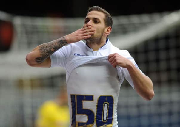 Billy Sharp celebrates a goal in a Leeds United shirt.