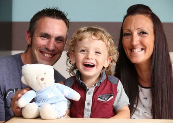 Oliver Roberts pictured with his dad Kriss and mum Clair Robinson.