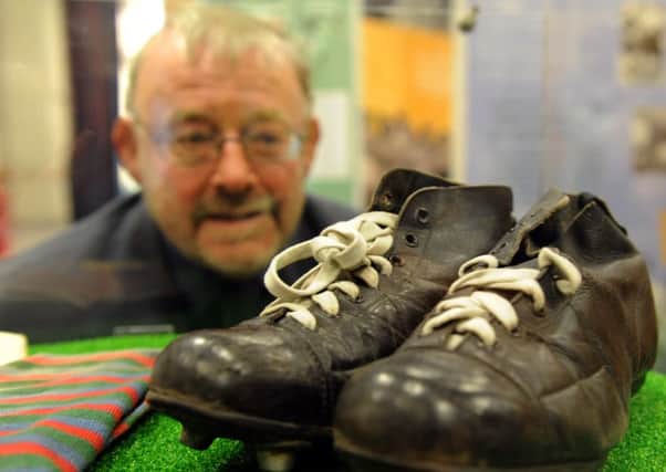 1/8/15  David Hinchliffe Chairman of the Trustees for the National Coal Mining Museum looking at the   rugby boots of  Brian Bevan an Australian player in the 1950's  part of  the Rugby League Cares Heritage Tour  which was at The National Mining Museum near Wakefield over the weekend. (GL1006/73f)