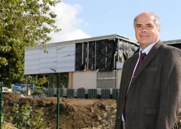 Work on a new Lidl supermarket and retail development in Knottingley is expected to be complete by October. Pictured Coun Graham Stokes
