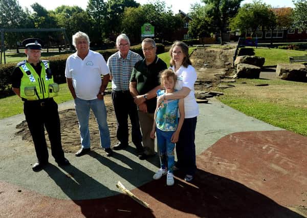Newspaper: Pontefract & Castleford Express.
Story: Vandals have tore up the soft tarmac children's play area at The Green, Airedale.
Pictured: PCSO Ash Sutton, Mick Hutchinson - Neighbourhood management team member, Richard Sloan - Vice chair, Mike Dixon - Chair, Debbie Borthwick (with Lucy) - team member.
Photo date: 12/08/15
Picture Ref: AB175a0815