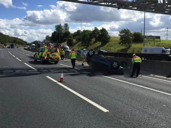 Car flips on its roof on M62. Picture tweeted by West Yorkshire Roads Policing Unit