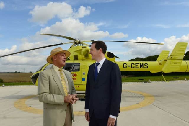 25 Aug 2015...Chancellor George Osborne chats with Geoffrey Boycott during a visit to the Yorkshire Air Ambulance facility at Nostell Priory near Wakefield. Picture Scott Merrylees SM1009/26a