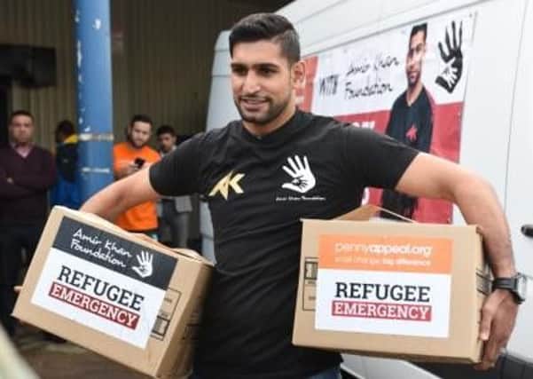 Boxer Amir Khan and the Penny Appeal  are helping refugees in Greece. Picture: Irfan Bostan