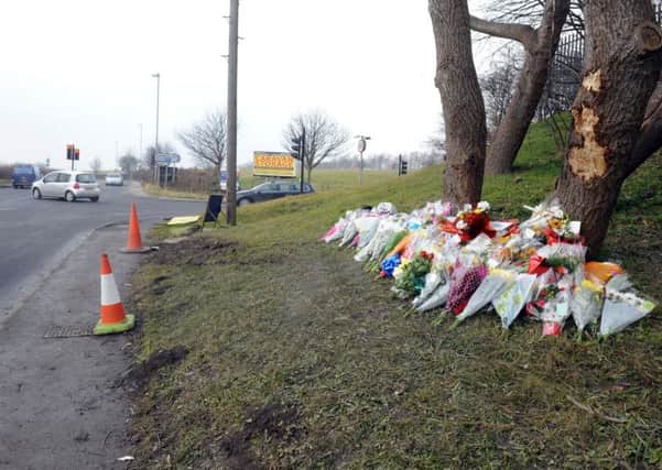 Floral tributes left at the scene in February.