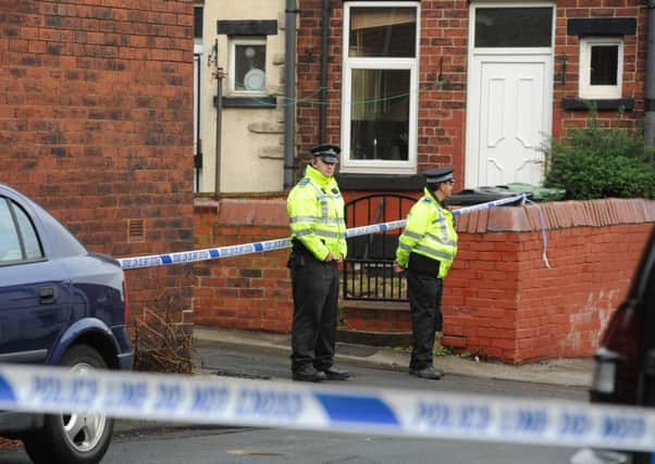 Police at the scene in Moorfield Avenue and Back Moorfield Terrace, Armley, Leeds. Picture: James Hardisty