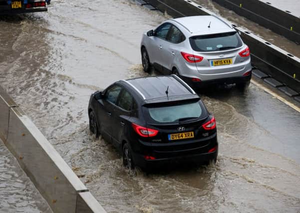 Traffic crawls through flood water both ways on the A1 between the two A6136 Catterick junctions following heavy rain overnight. Highways are working to pump the water away and alleviate the traffic. October 7 2015.