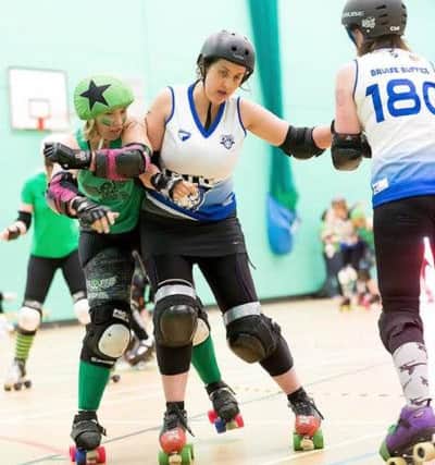 Retiring Wakey Wheeled Cats skater Louise Edwards goes in for a big hit. Picture: Richard Nicholson
