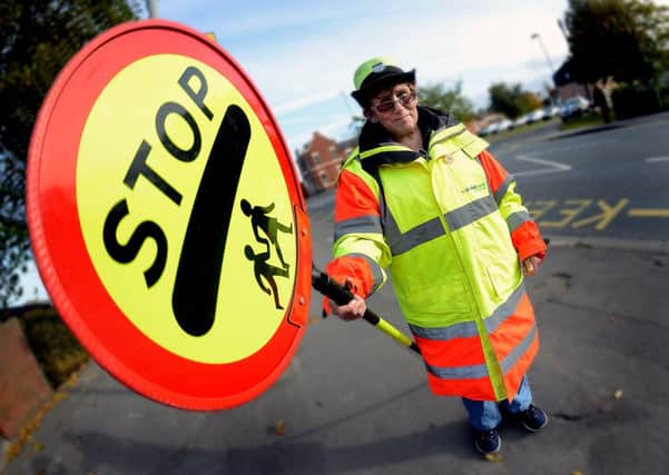 Newspaper: Pontefract & Castleford Express. Story: Lollipop lady Janet Tate has worked at St Thomas' Junior School for 25 years. Photo date: 20/10/15 Picture Ref: AB328a1015