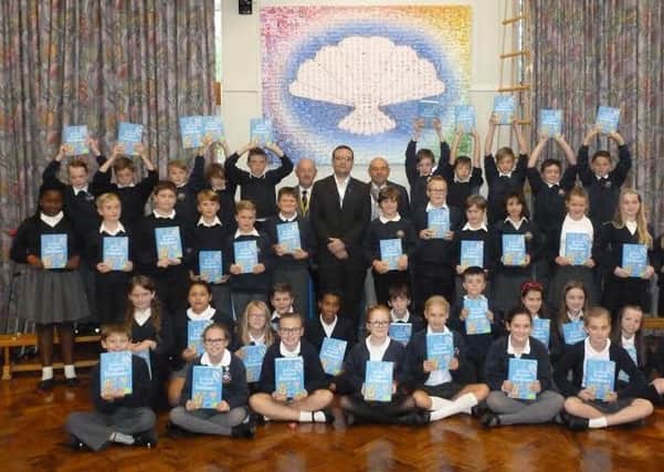 Year 6 pupils at St James CE Primary Academy proudly show off their Dictionaries4Life after the presentation at the school. At the rear centre are Dick Wood, Communities Member of the Rotary 
Club, Glyn Denton, the Headmaster of St James and Bob Guard, President of the Wakefield Chantry Rotary Club.