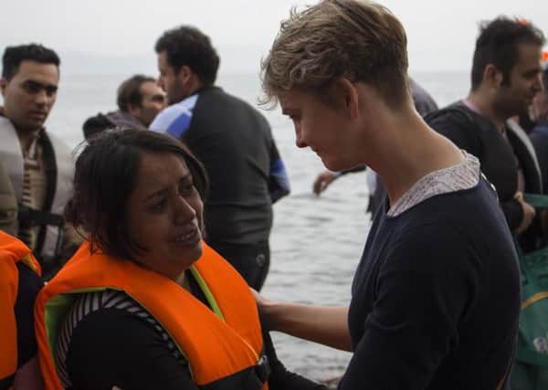 Ms Cooper meets one of the refugees arriving on the island.