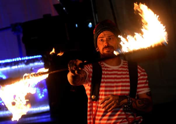 A fire eater performs at the switch-on.