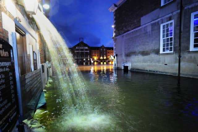 Riverside properties in York city centre pump out flood water as the River Ouse continues to rise after several days of torrential rain.