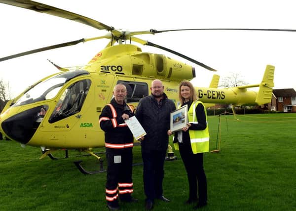 Newspaper: Hemsworth Express.
Story: Mark Larkin, cousin of teenager Bethany Jones, gets award from Yorkshire Air Ambulance for raising thousands of pounds for them, through a charity set up in Bethany's memory.
L to R) Andy Hall - helicopter pilot, Mark Larkin, Kerry Garner - Yorkshire Air Ambulance representative.
Photo date: 24/11/15
Picture Ref: AB539a1115