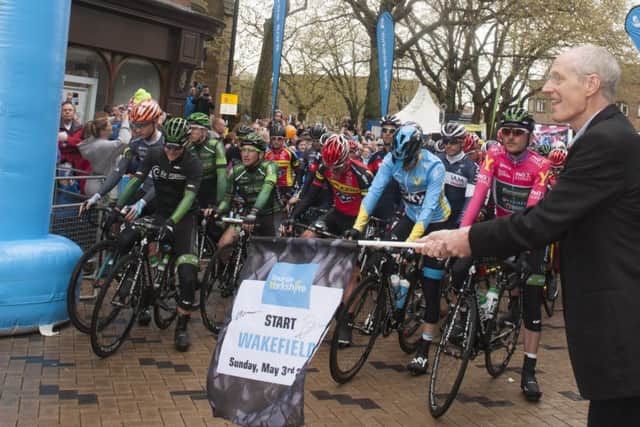 Cllr Peter Box drops the flag as the riders prepare for stage 3 of the Tour de Yorkshire in Wakefield