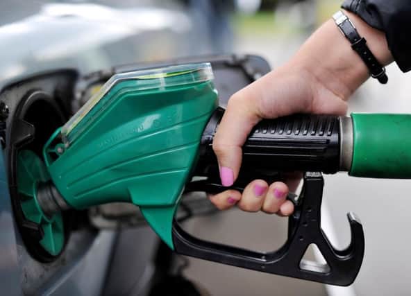 A person using an Asda petrol pump. Nick Ansell/PA Wire