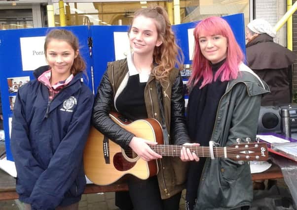 Aine Cooper, left, Sarah Stevenson and Lois Hill, entertained market shoppers in a prelude to Pontefract Music Festival.