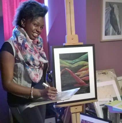 Wakefield artist Hoshi Dee with some of her work