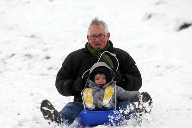 Louis Mcguire aged 2 with grandad Charlie McDowall, enjoy the snow at Ilkley Moor. (Picture by Simon Hulme)