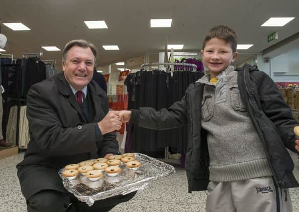 Ed Balls hands out mince pies to Jake Lawson in Morley.