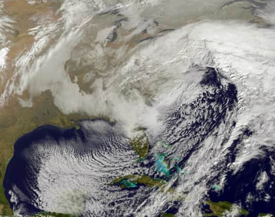 This image taken by NOAA's GOES-East satellite on Thursday, January, 23, 2016, at 9:37 a.m. EST, shows a large winter snowstorm over the East Coast of the United States. It is now heading to the UK. (NOAA GOES Project/NASA via AP)