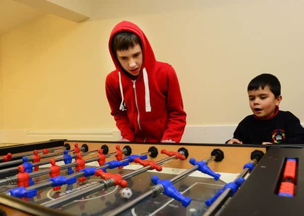 19 Jan 2015...... Danny Hopton and Theo Cutts have a game of table football at the launch a new Autistic Spectrum youth group, called Fusion in Wakefield. Picture Scott Merrylees
