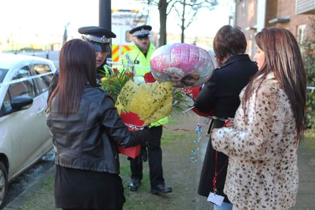 Wellwishers have left flowers at the scene in Allerton Bywater where three bodies were found yesterday. Picture: Ross Parry Agency
