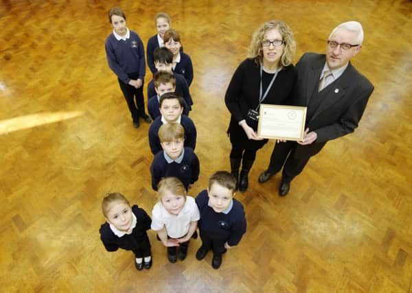 Pontefract Civic Society is launching a junior civic society to help engage school pupils in civic issues. Carleton is first school to sign up.
Paul Cartwright (chairman of Pontefract civic society) with Sarah Soltysek (leadership team) and the school council.