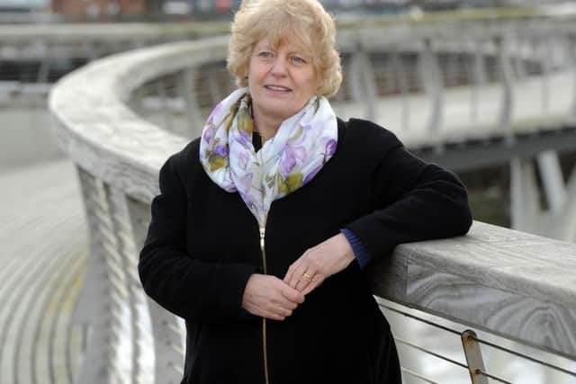 Date:4th March 2014. Picture James Hardisty (JH1002/74f). Pictured Alison Drake, from Castleford Heritage Trust, on the award winning pedestrian bridge over the River Aire at Castleford, close to the Queens Mill.