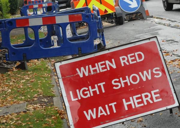 Temporary traffic lights to cause delays.