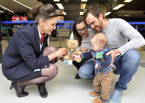 April Clements from British Airways with Scott and Coral Cranmer, their nine month old son - and Pooh.