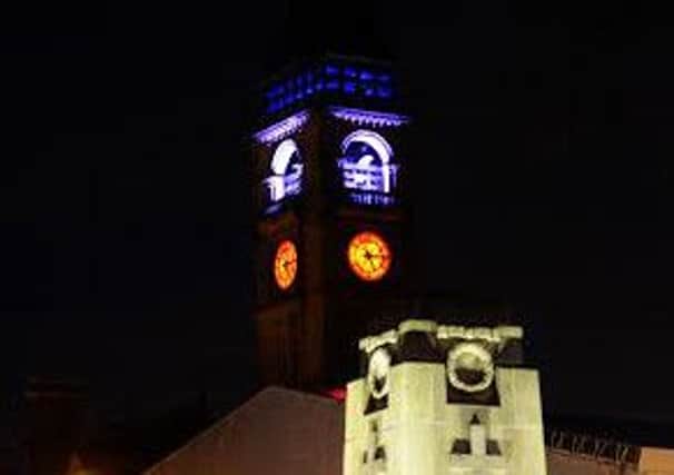 Wakefield Town Hall clock tower lit up in red,white and blue after the Paris terrorist attacks. Picture Scott Merrylees