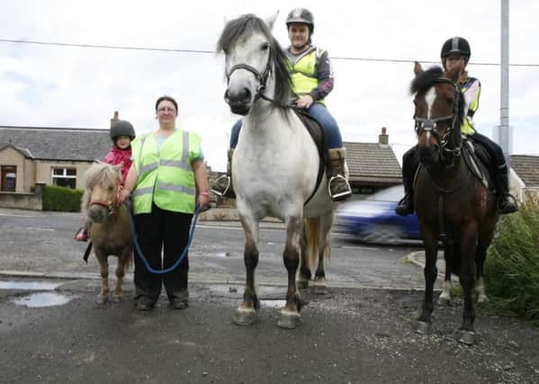Joann Pollock says that drivers have no idea how to act when passing horses on the road. She is pictured with Lucy Corroon on Halle; Lauren Hamilton on Merlin and Sophie Corroon on Coco.