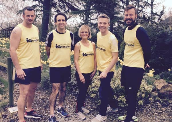 MISSION: Rev Darren McClintock, second left, and a team of hospice runners are doing the London Marathon.