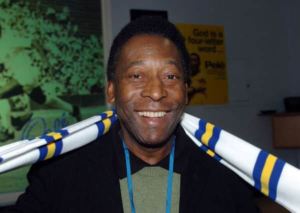 Pele dons a Leeds United scarfe during his visit to  ASDA House Leeds